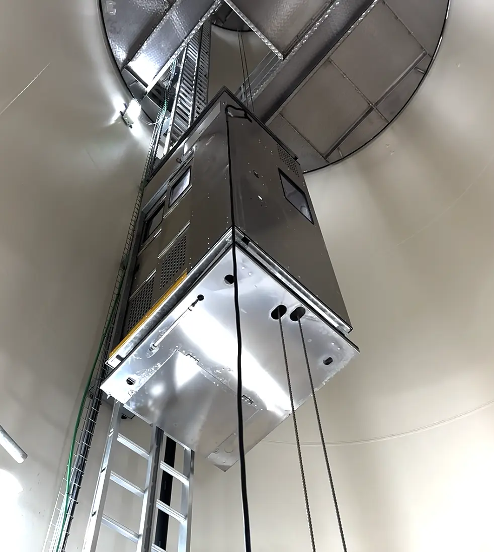 Ladder-guided service lift for wind turbines