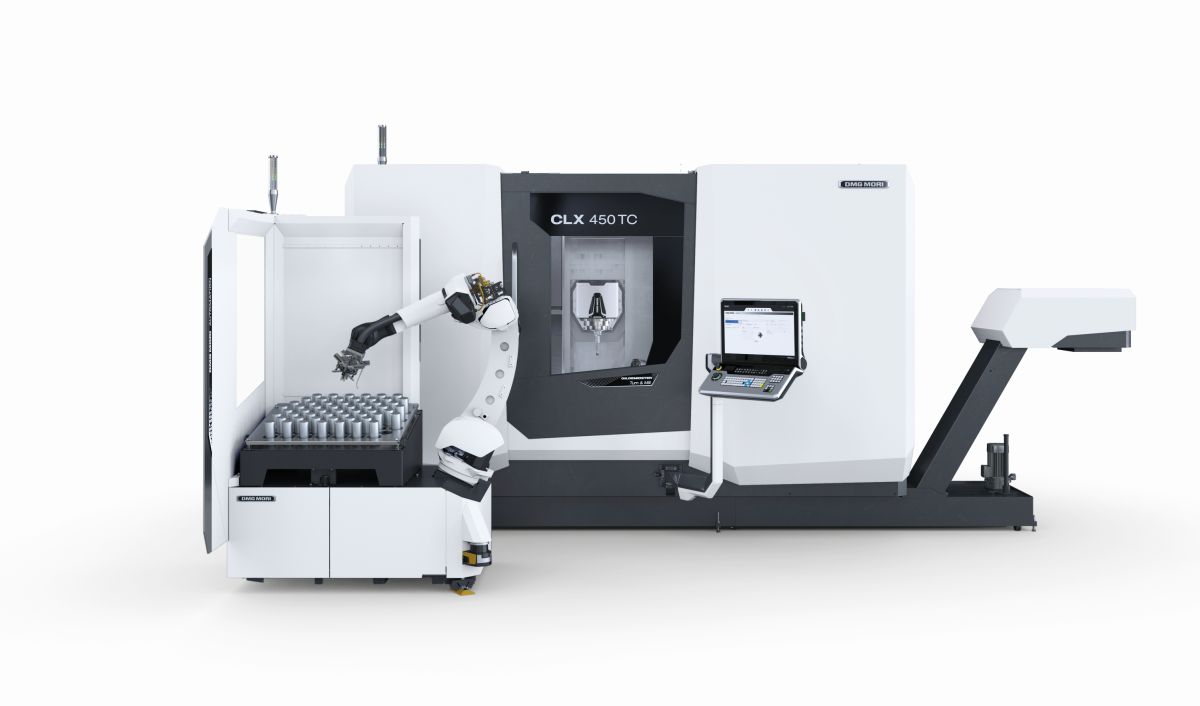 CNC machine with robotic arm and control monitor
