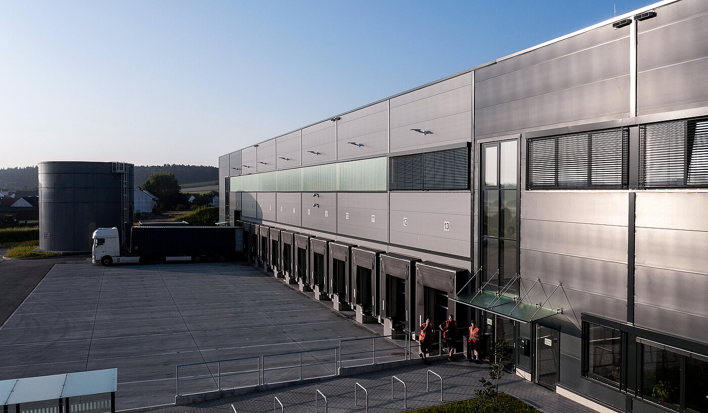 Completed logistics hall with trucks and staff