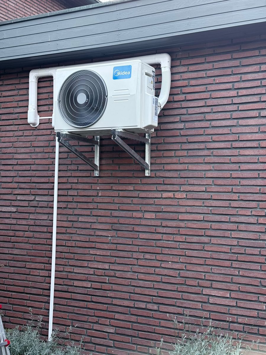 Outdoor unit on wall bracket on brick facade