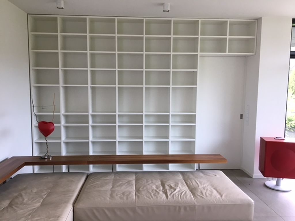 Floor-to-ceiling shelving wall with bench